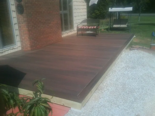 Freshly stained wood deck built against a brick home in Schnecksville