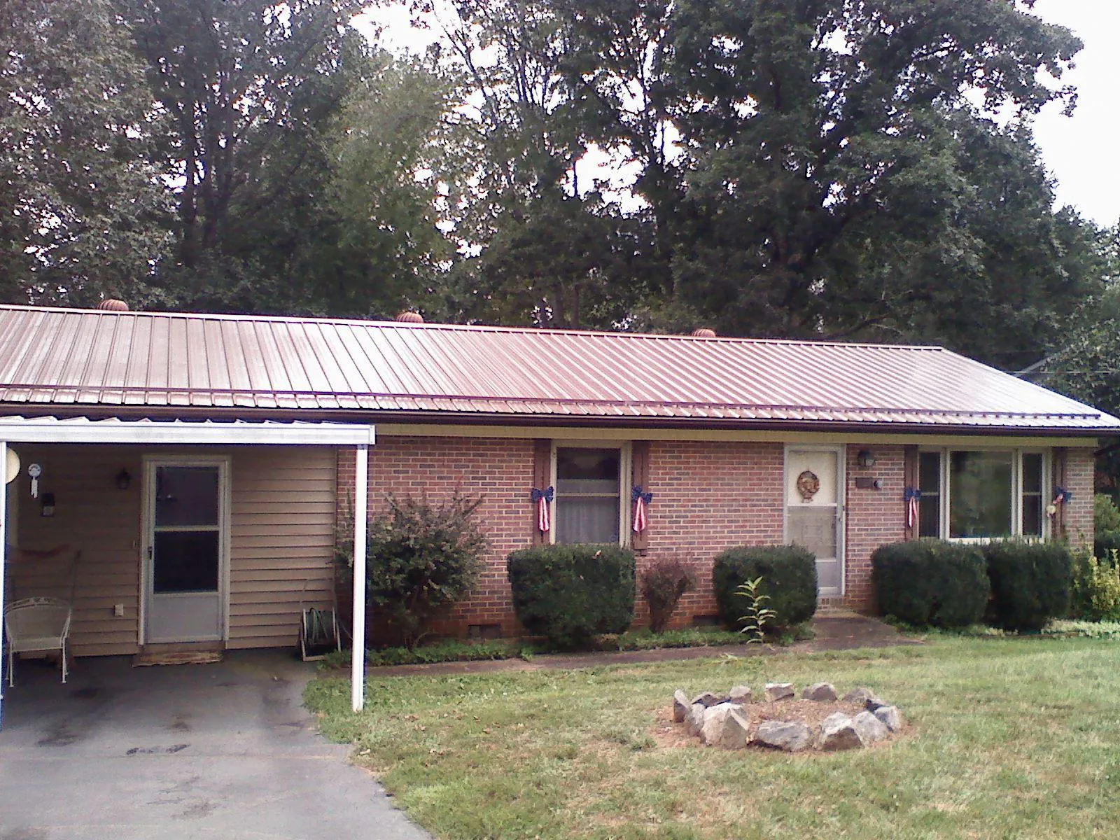 Bronze metal roof and carport on a brick ranch home — Roof Repair work by our crew in Schnecksville