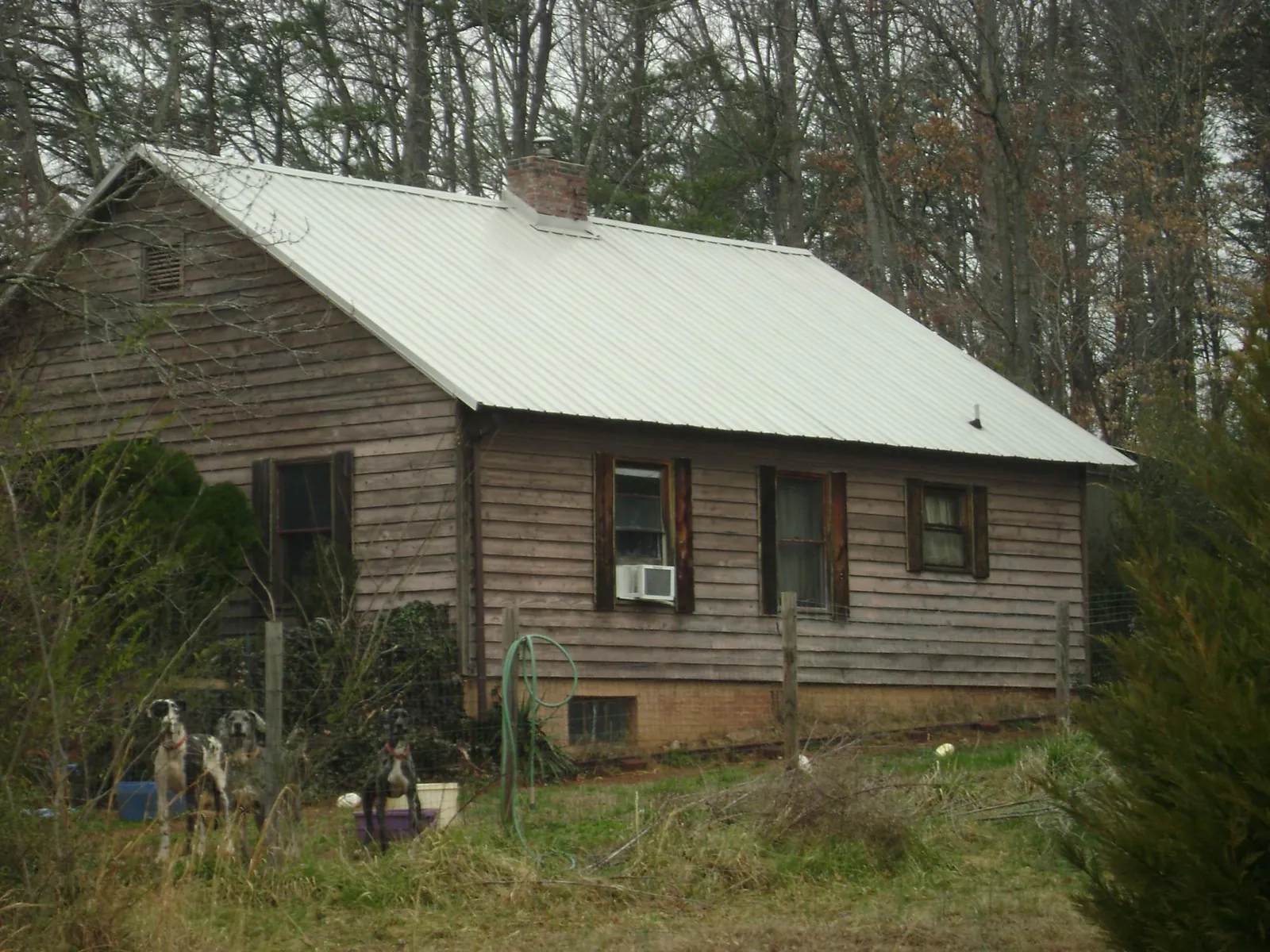 White metal roof on an old wood sided farmhouse, from a Asphalt Shingle Roof Repair job in Schnecksville